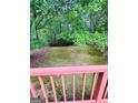 A view of the natural backyard perfect for enjoying outdoor living from the privacy of the deck at 35 Hampton Oaks Dr, Hampton, GA 30228