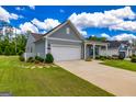 Single-story home with attached two-car garage and well-manicured lawn, showcasing suburban living at 326 Elkins Pl, Peachtree City, GA 30269