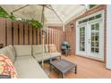 Cozy backyard patio with comfortable sectional seating, umbrella, grill, and privacy fence at 3502 Village Green Dr, Roswell, GA 30075