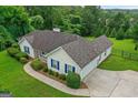 Beautiful home featuring a well-manicured lawn, mature landscaping and a long driveway at 227 Ferguson Ave, Locust Grove, GA 30248