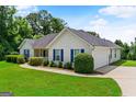 Beautiful home featuring a well-manicured lawn and an attached two-car garage at 227 Ferguson Ave, Locust Grove, GA 30248