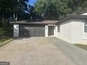 Inviting one-story home boasting a well-maintained driveway and an attached garage at 6178 Graceland Cir, Morrow, GA 30260