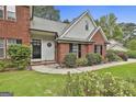 Attractive brick home with a black front door and manicured landscaping at 128 Rubicon Rd, Peachtree City, GA 30269