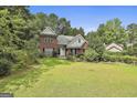 Traditional brick home with a manicured lawn and mature trees at 128 Rubicon Rd, Peachtree City, GA 30269
