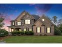 Charming front exterior with a covered porch, manicured lawn, and a blend of stone and brick accents at 4830 Northridge Dr, Cumming, GA 30040