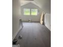 Finished attic space with new floors and natural light from the windows at 1551 Broad Ne St, Conyers, GA 30012