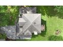 Aerial view showcases roof architecture, backyard with trees and a patio at 115 Rockhurst Chase, Tyrone, GA 30290
