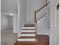 View of the Entryway showing the beautiful stairway and hardwood floors at 115 Rockhurst Chase, Tyrone, GA 30290