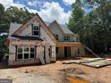 New home construction showing the framing of a two story structure with front porch in wooded area at 651 Burg Rd, Locust Grove, GA 30248