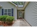 Close up of front porch with storm door, house number, and manicured bushes at 40 Riverside Pkwy, Sharpsburg, GA 30277