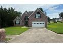 Attractive two-story brick home boasting a well-kept lawn, a spacious driveway, and a two-car garage at 12189 Lauren Way, Fayetteville, GA 30215