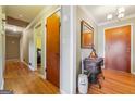 Hallway with hardwood flooring, showcasing neutral walls and decorative mirror at 3212 Georgian Woods Cir, Decatur, GA 30034
