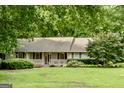 Inviting home featuring a cozy front porch, shuttered windows, and a lush green lawn at 1624 Hampton Locust Grove Rd, Locust Grove, GA 30248