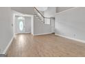 Bright living room featuring neutral colors, hardwood floors, and staircase at 105 Rosewood Cir, Covington, GA 30016