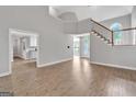 Bright living room featuring neutral colors, hardwood floors, and staircase at 105 Rosewood Cir, Covington, GA 30016