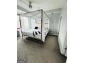 Stylish bedroom featuring a unique four-poster bed and neutral decor at 285 Centennial Olympic Park Drive Northwest Nw Dr # 1905, Atlanta, GA 30339