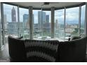 Bright living room with floor-to-ceiling windows showcasing a stunning city skyline view at 285 Centennial Olympic Park Drive Northwest Nw Dr # 1905, Atlanta, GA 30339