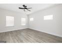 Spacious bedroom with three windows, light walls and ceiling fan at 52 Cantrell Drive, Dallas, GA 30157