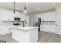 Modern kitchen with stainless steel appliances, white cabinets, and center island at 52 Cantrell Drive, Dallas, GA 30157