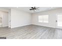 Bright living room features wood floors, a ceiling fan and a patio door at 52 Cantrell Drive, Dallas, GA 30157