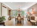 Formal dining room featuring a large window, elegant chandelier, and classic furnishings at 606 Wingspread, Peachtree City, GA 30269