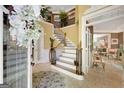 Grand foyer with a curved staircase and detailed wrought iron railing at 606 Wingspread, Peachtree City, GA 30269