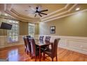 Formal dining room features hardwood floors, a tray ceiling, and elegant wainscoting at 705 Lawton Bridge Sw Rd, Smyrna, GA 30082