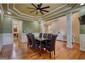 Dining room with hardwood floors, decorative columns, and a view into the adjoining living spaces at 705 Lawton Bridge Sw Rd, Smyrna, GA 30082