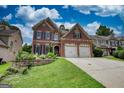 Attractive two-story brick home with two-car garage and a landscaped yard at 705 Lawton Bridge Sw Rd, Smyrna, GA 30082