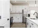 Modern kitchen featuring white cabinets, stainless steel appliances, quartz countertops, and subway tile backsplash at 586 Cantrell Drive, Dallas, GA 30157