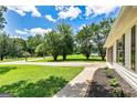 Well-maintained front yard with lush landscaping and a view of the house siding, inviting curb appeal at 125 Selena Ct, Fayetteville, GA 30215