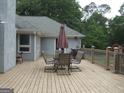 Outdoor back deck with patio table and chairs for outside entertainment at 1455 River Cove Rd, Social Circle, GA 30025