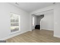 Bright living room with wood floors and a large window overlooking a green lawn at 676 Cantrell Drive, Dallas, GA 30157