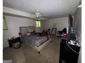 Bedroom with carpet, ceiling fan, and a window allowing for natural light at 6884 Red Maple Ct, Rex, GA 30273