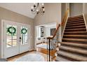 Bright entryway featuring French doors, staircase, tile flooring, and a view to the front yard and a home office at 103 Sandtrap Rdg, Peachtree City, GA 30269