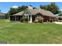 Spacious backyard featuring a screened-in porch and well-maintained lawn, perfect for outdoor enjoyment at 9361 Arbor Glenn Ct, Jonesboro, GA 30236