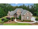 Well-maintained exterior with manicured landscaping and stone accents at 185 Platinum Ridge Pt, Fayetteville, GA 30215