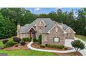 Charming home with lush greenery, stone facade and manicured garden beds at 185 Platinum Ridge Pt, Fayetteville, GA 30215