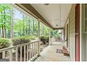 The welcoming front porch provides a perfect spot to enjoy the serene surroundings and curb appeal at 215 Longwood Dr, Jonesboro, GA 30236