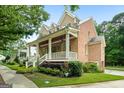 Side view of brick home with a welcoming front porch and beautiful yard at 5130 Pratt Sw St, Covington, GA 30014