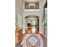 Grand foyer with hardwood floors, detailed millwork, and view into the living area and an upstairs balcony at 260 Bonnie Ln, Fayetteville, GA 30215