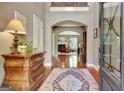 Elegant foyer with hardwood floors, detailed millwork, and view into the living area with fireplace at 260 Bonnie Ln, Fayetteville, GA 30215