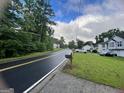 A view of a neighborhood street featuring well-kept lawns and diverse home designs at 8519 Glenwoods Dr, Riverdale, GA 30274