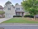 Traditional two-story home with a manicured lawn and attached two-car garage in a neighborhood setting at 522 Blue Mountain Rise, Canton, GA 30114