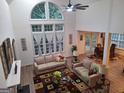 Bright living room featuring soaring ceilings, large windows, hardwood floors, and modern decor at 522 Blue Mountain Rise, Canton, GA 30114