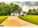 View of the long driveway leading to a spacious home with an attached garage at 40 Westbrook Rd, Carrollton, GA 30116