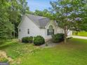 Well-kept home exterior with vinyl siding, manicured landscaping, and a peaceful, private setting at 52 Cherub Ln, Sharpsburg, GA 30277