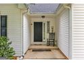 Inviting front porch featuring decorative elements and a comfortable rocking chair, adding charm and character at 52 Cherub Ln, Sharpsburg, GA 30277