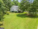 Expansive, green lawn surrounding a lovely home, offering plenty of space and scenic views at 52 Cherub Ln, Sharpsburg, GA 30277