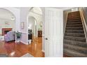 Open entryway with hardwood flooring, arched doorways, and stairs to the second floor at 1010 Capella Creek Way, Grayson, GA 30017